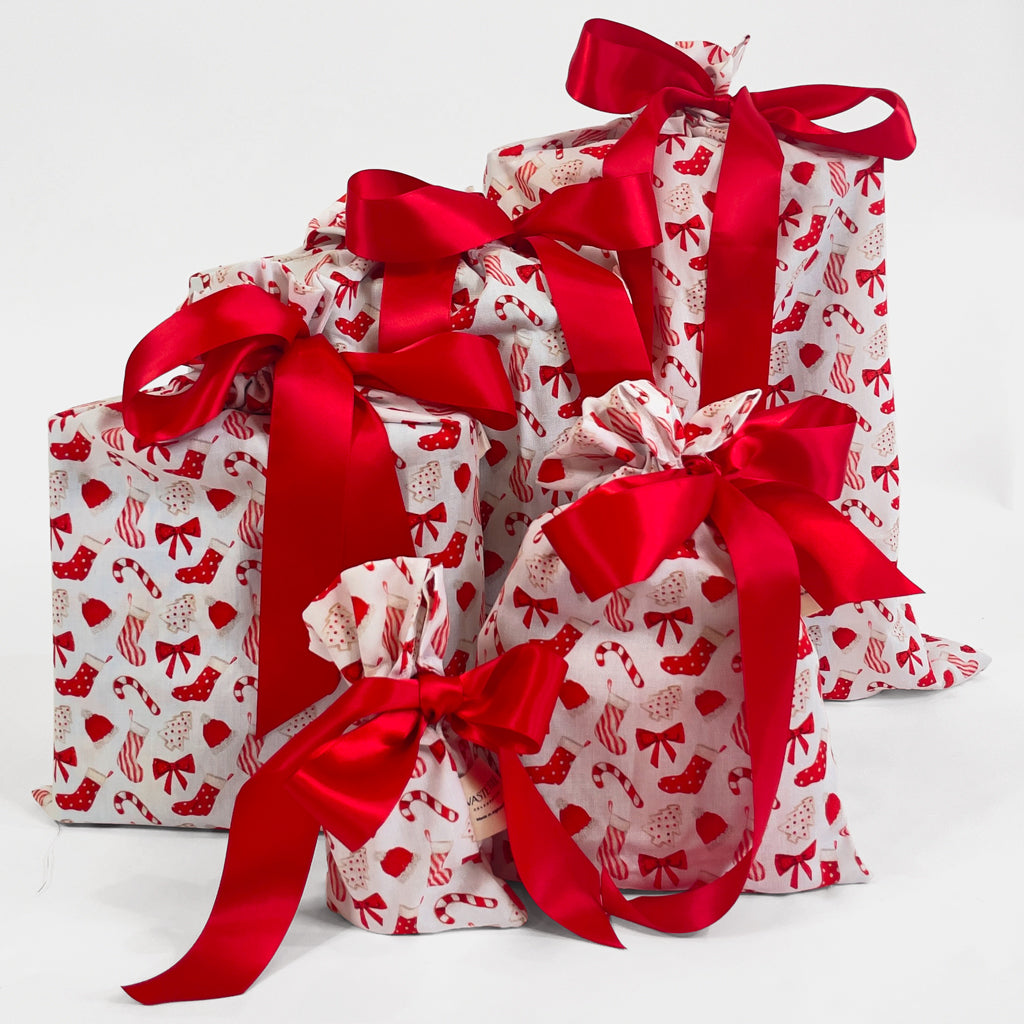 Set of 5reusable gift bags. Traditional red and white design with christmas cookies and candy.