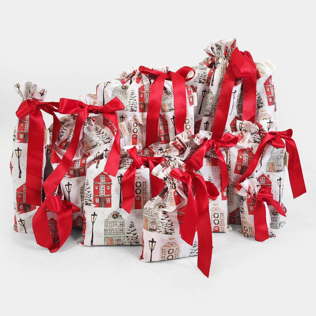 Set of 10 reusable gift bags, including a huge santa sack. Red and white Christmas cottages design.