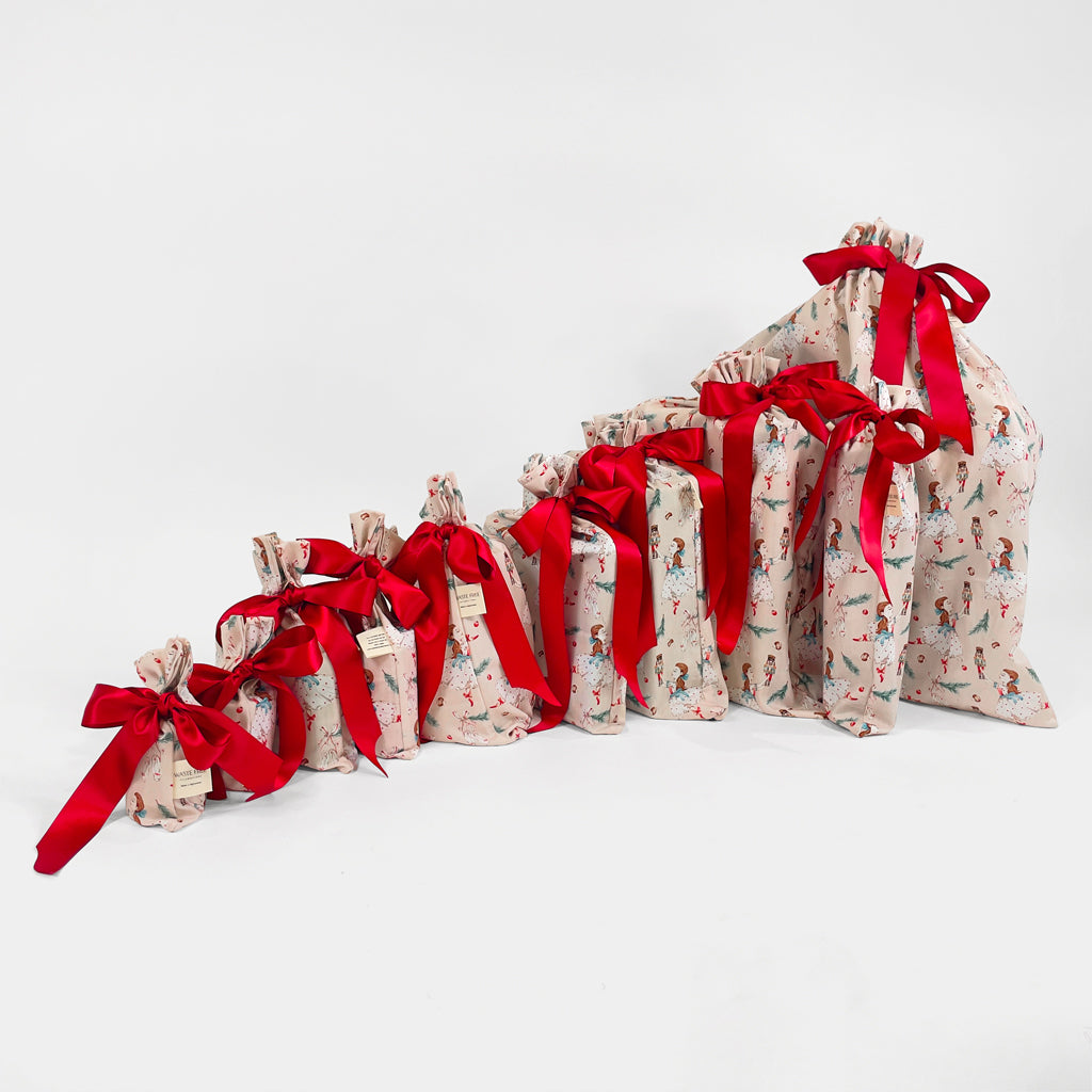 Set of 10 reusable gift bags including a huge santa sack. In a hand-painted design featuring Clara dancing with the Nutcracker.