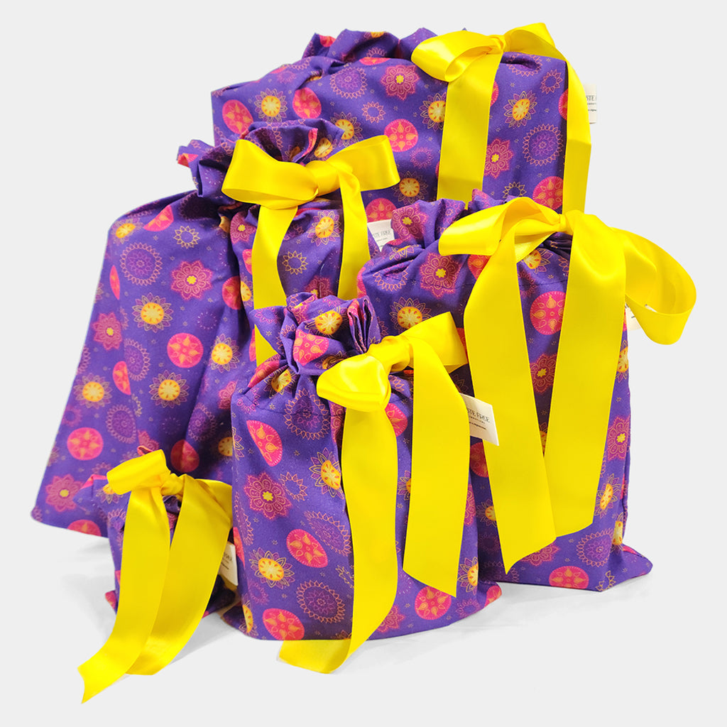 Set of 5 reusable gift bags in a vibrant purple and hot pink mandala design with a bright yellow bow suitable for Diwali