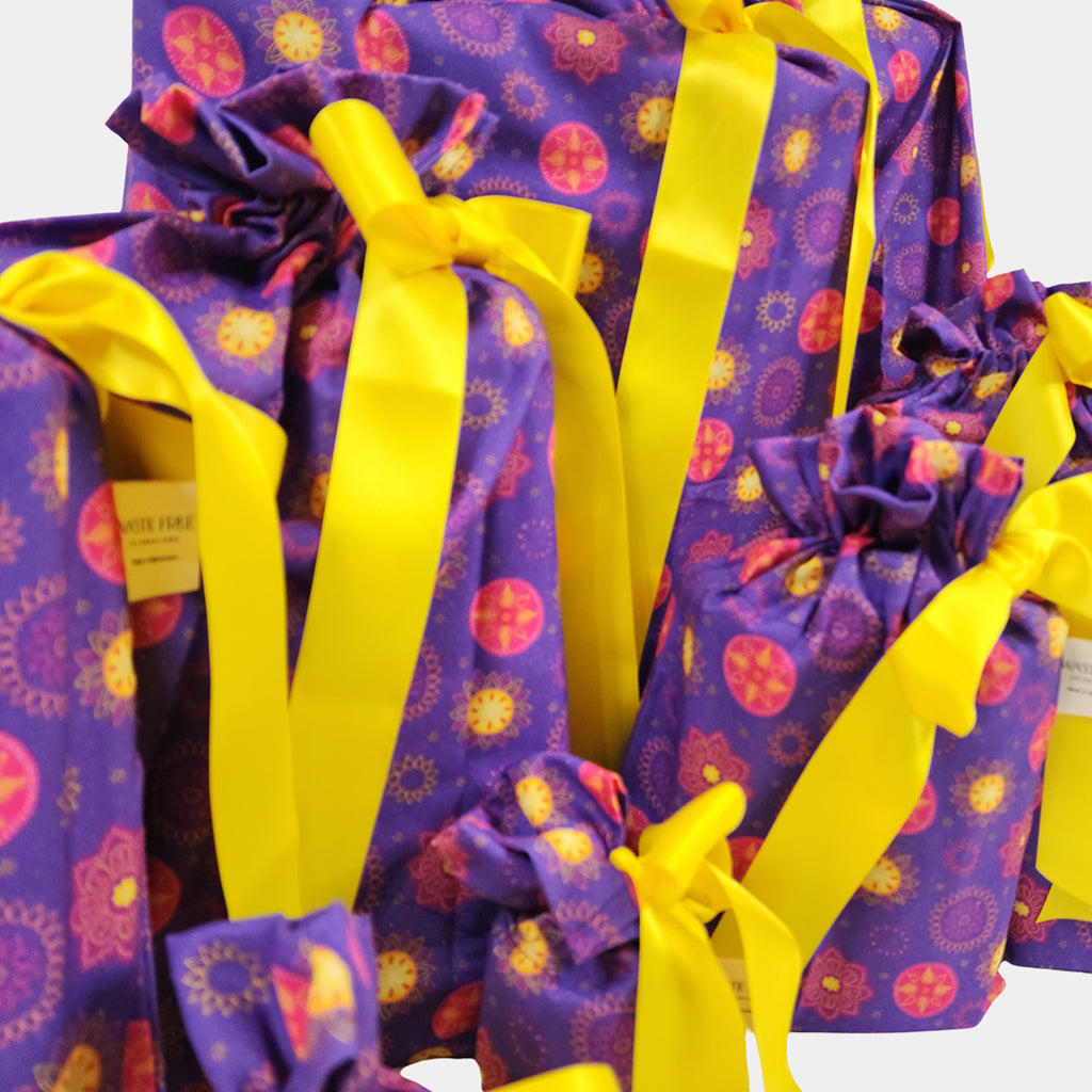 Set of 10 reusable gift bags including a huge santa sack in a vibrant purple and hot pink mandala design with a bright yellow bow suitable for Diwali
