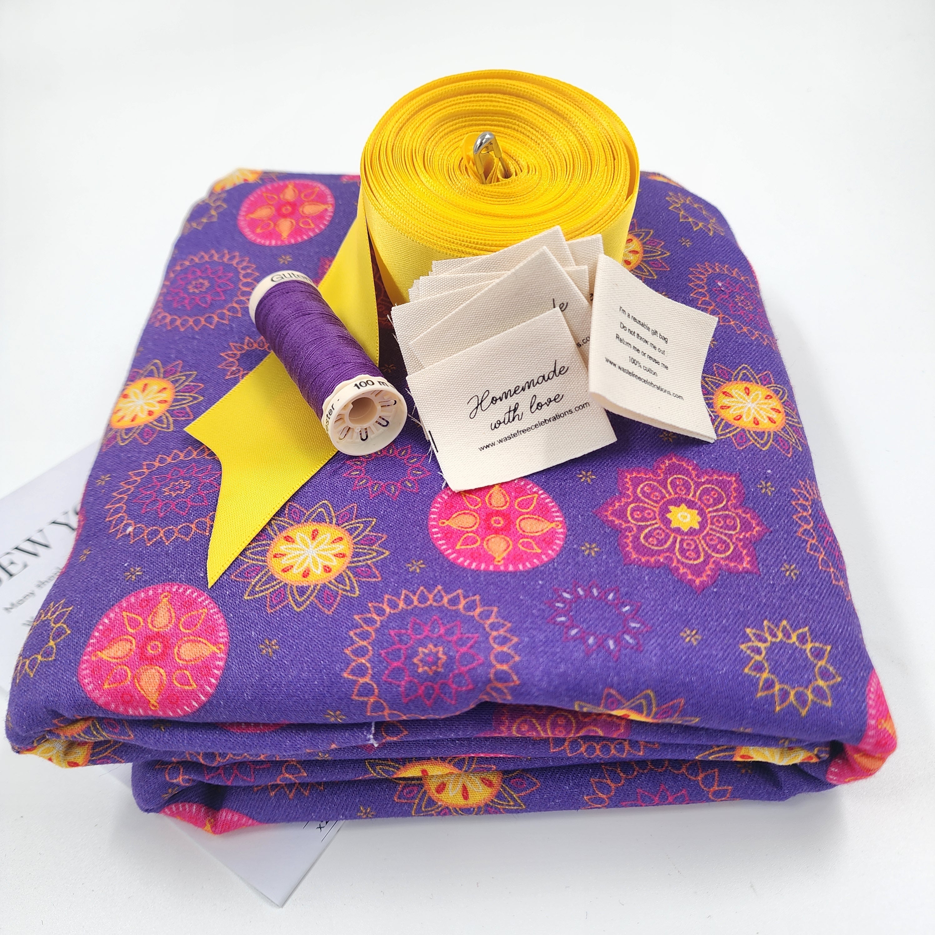 Sew Your Own kit for Set of 10 reusable gift bags including a huge santa sack in a vibrant purple and hot pink mandala design with a bright yellow bow