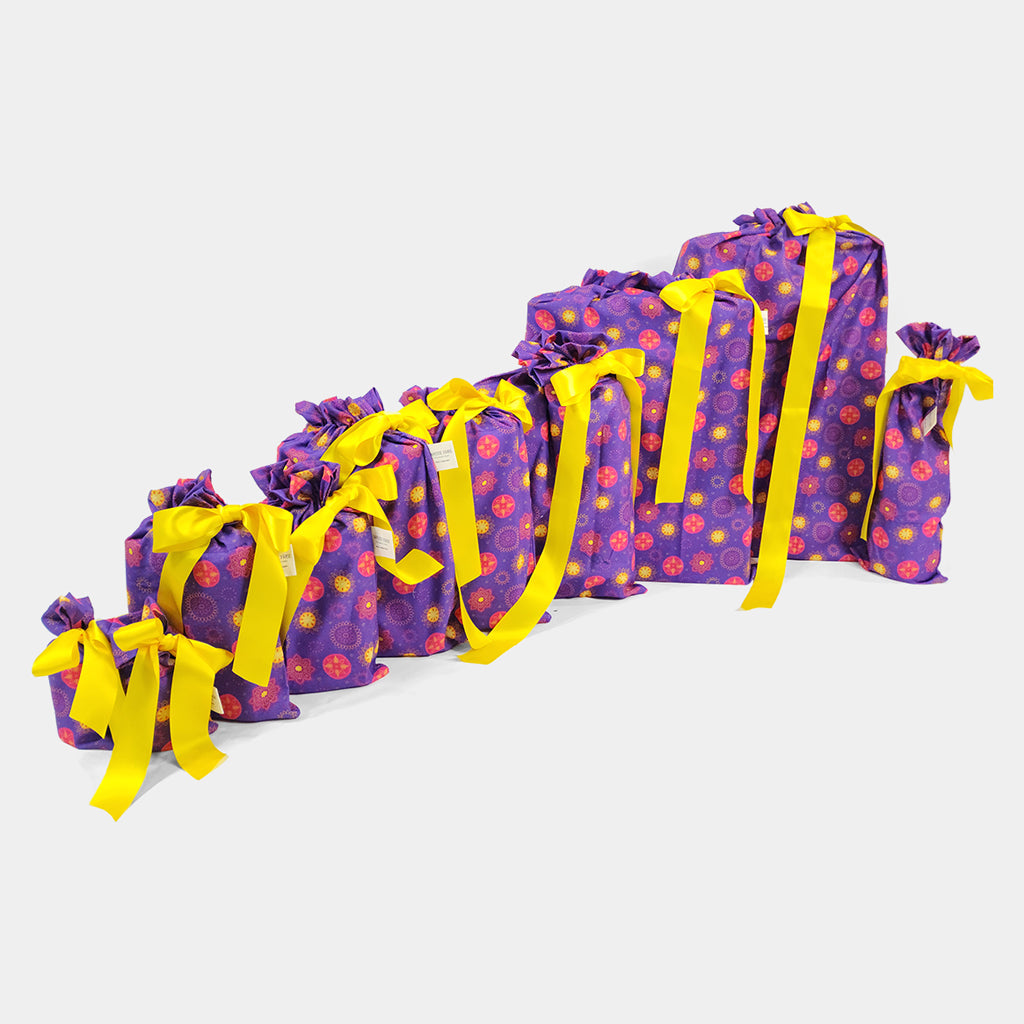 Set of 10 reusable gift bags including a huge santa sack in a vibrant purple and hot pink mandala design with a bright yellow bow suitable for Diwali