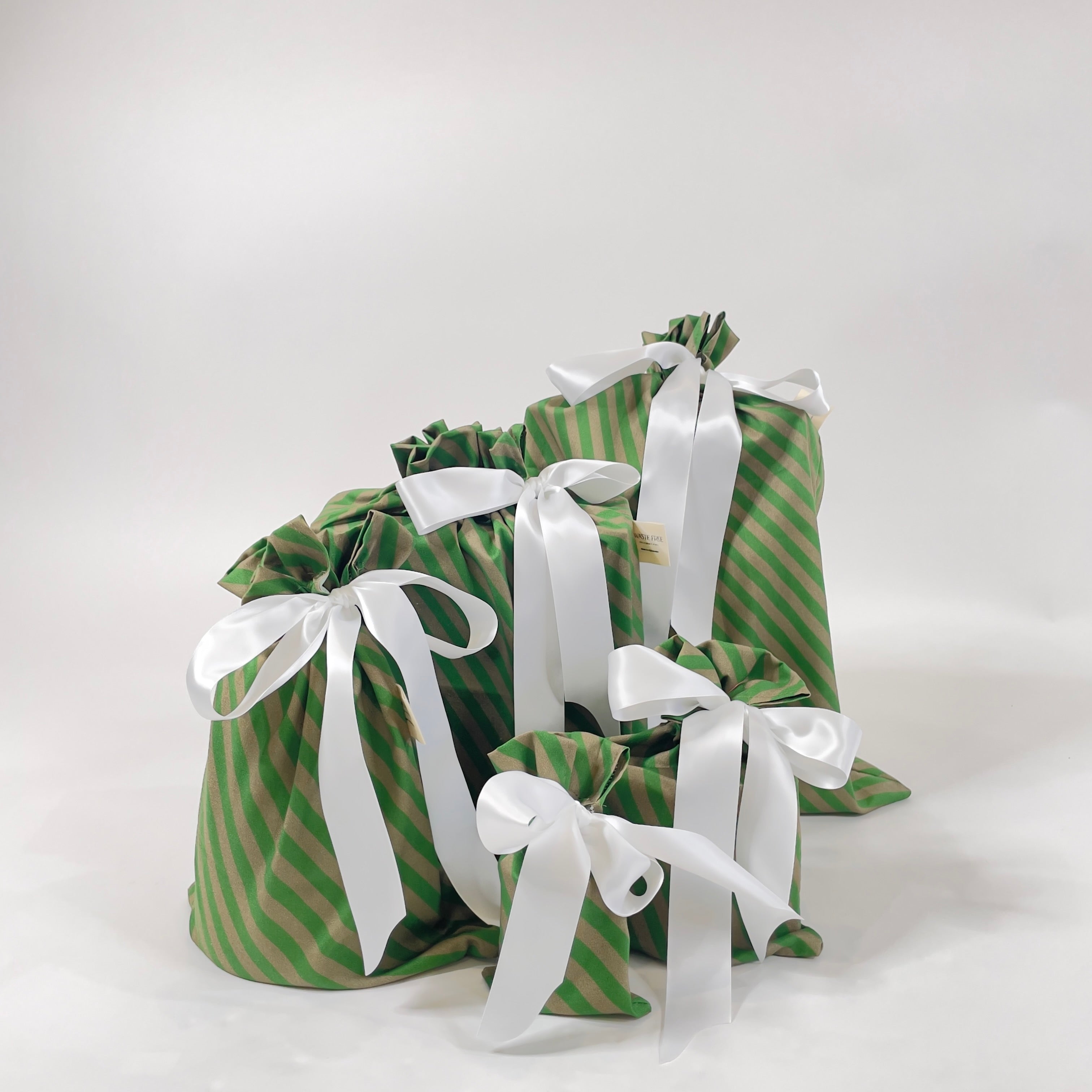 Set of 5 reusable gift bags in a design of green and brown stripes with a large white bow.