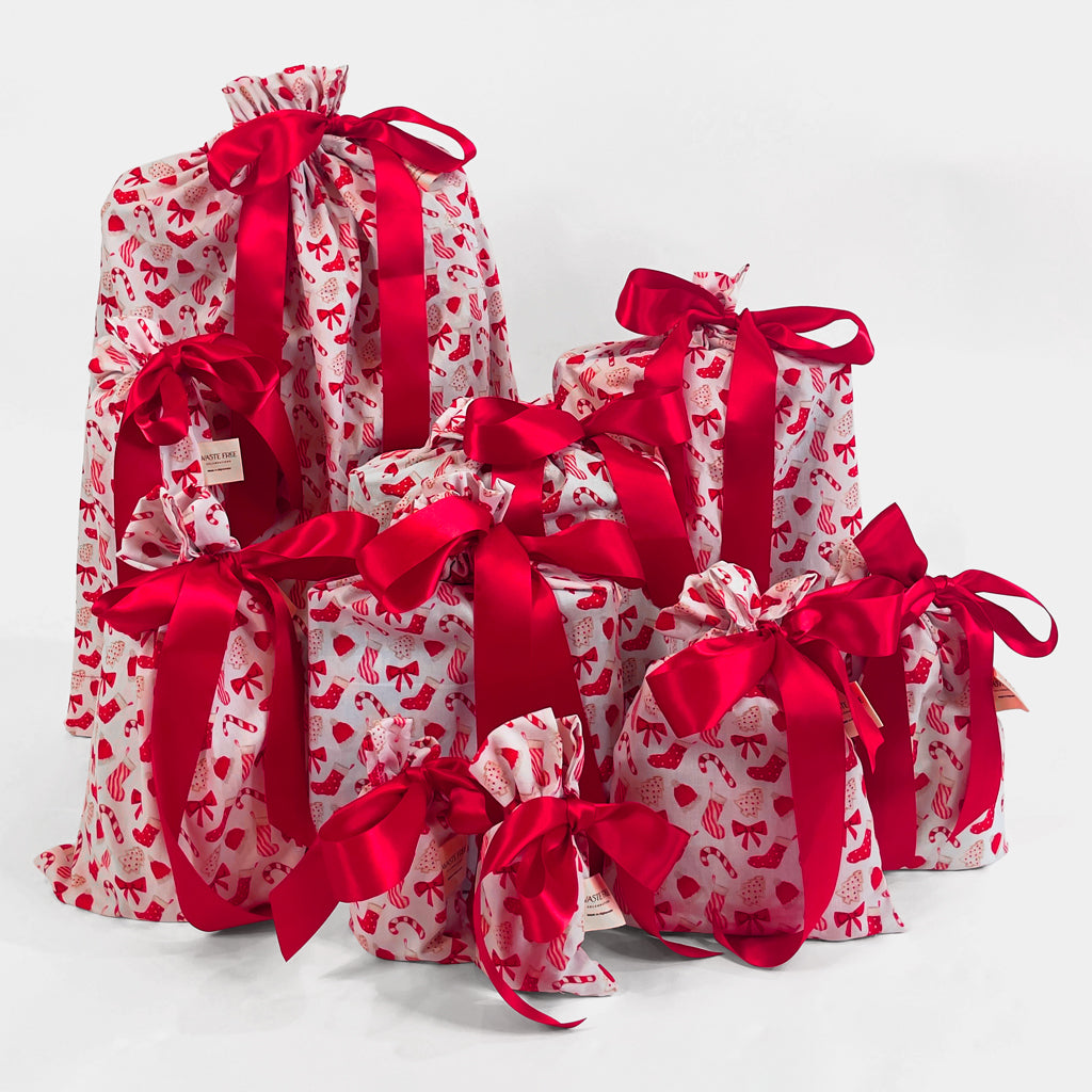 Set of 10 reusable gift bags, including a santa sack. Traditional red and white design with christmas cookies and candy.