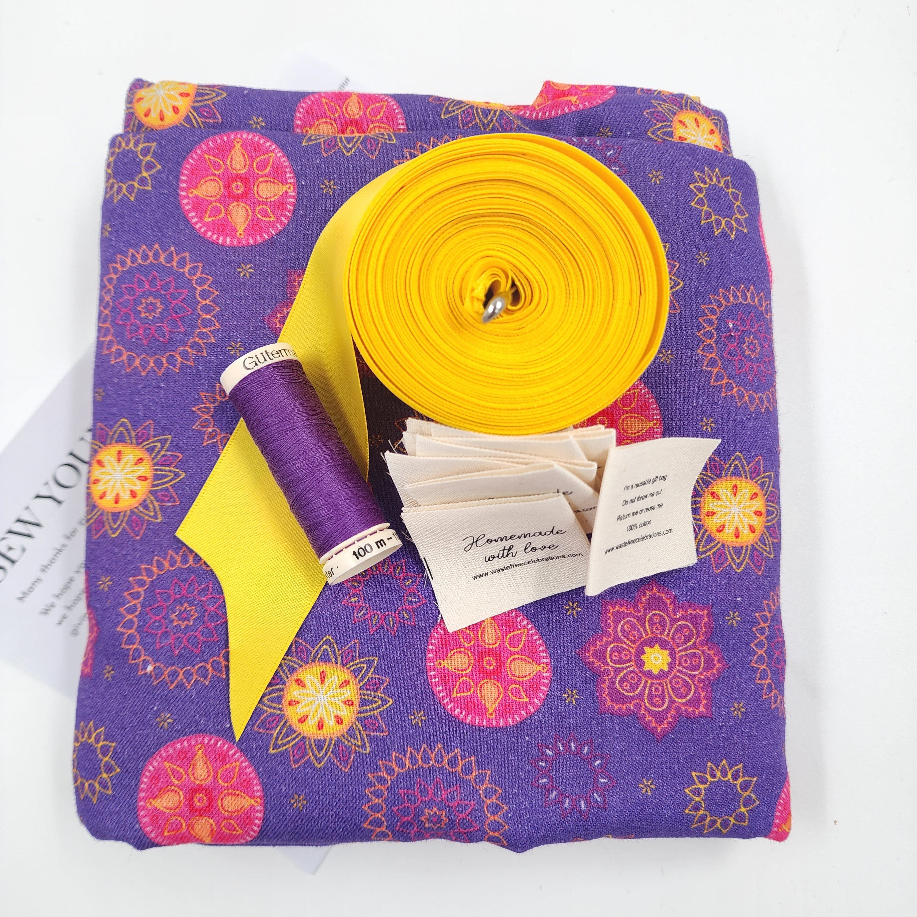 Sew Your Own kit for Set of 10 reusable gift bags including a huge santa sack in a vibrant purple and hot pink mandala design with a bright yellow bow