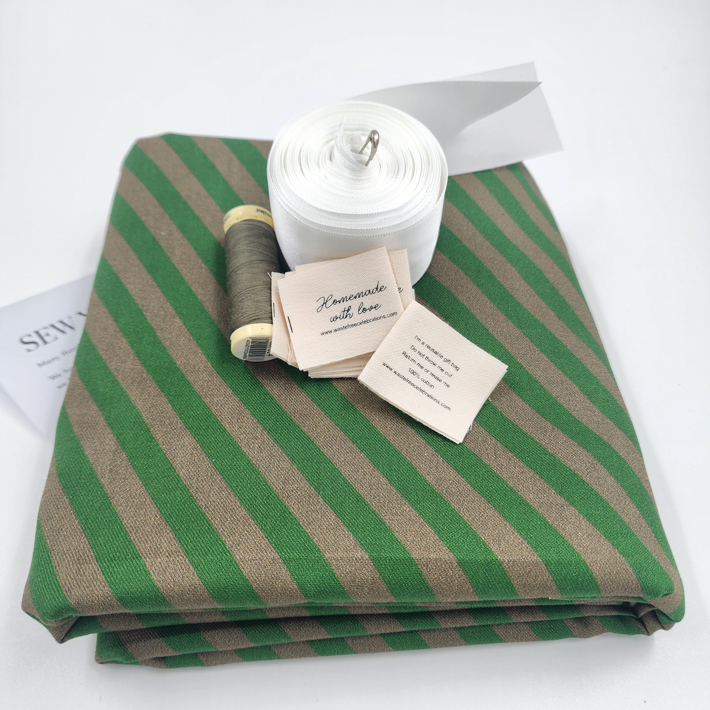 Set of 10 reusable gift bags including a huge santa sack in a design of green and brown stripes, with a large white bow. 