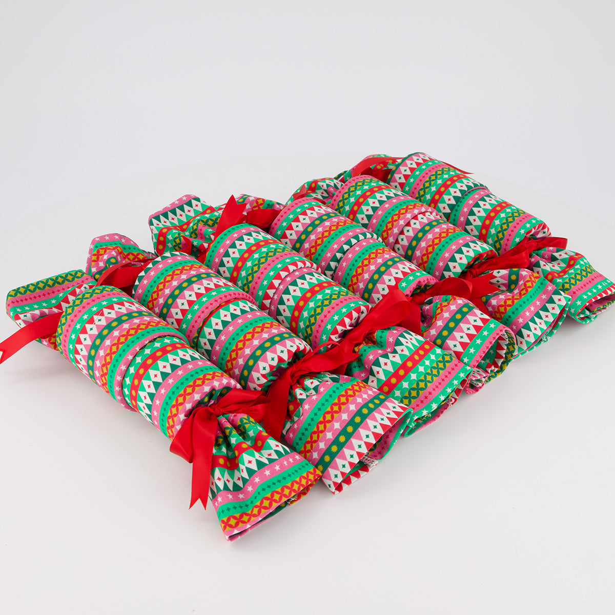 Fiesta reusable Christmas crackers — 6 crackers unboxed in a row — modern colourful geometric design — handmade in Afghanistan