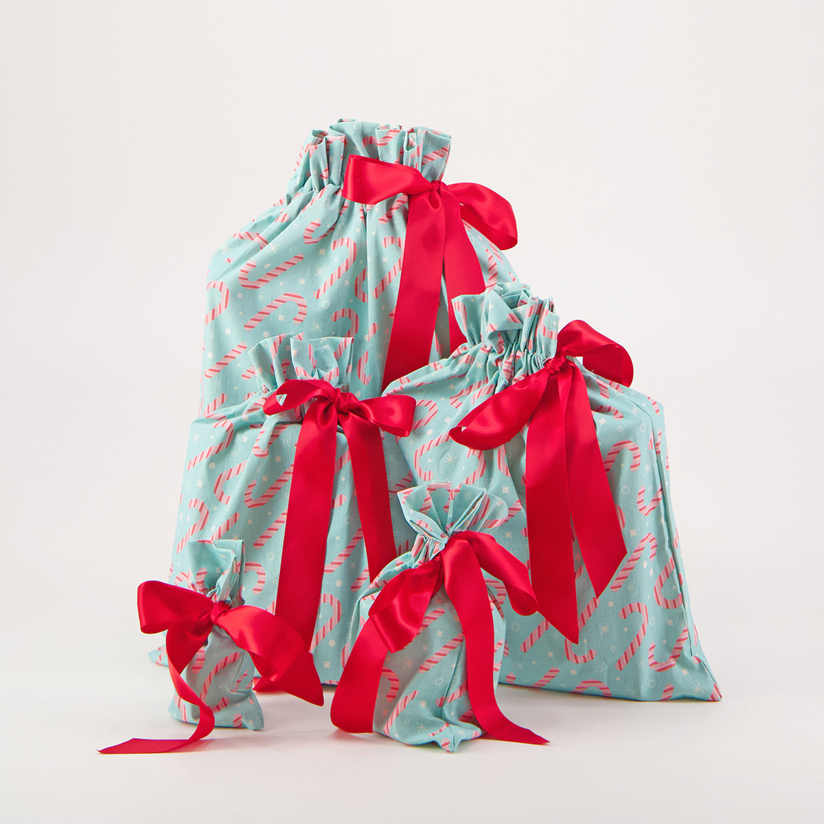 Dulces reusable gift bag set of 5 — candy cane print in pink and white on mint green — handmade in Afghanistan